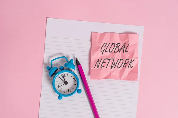 Writing note showing Global Network. Business photo showcasing Any communication system which spans the entire Earth Striped paper sheet note pencil vintage alarm clock colored background. — Stock Photo, Image