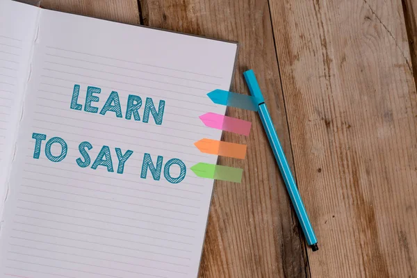 Conceptual hand writing showing Learn To Say No. Business photo text decline or refuse few things before you destroy yourself Striped notebook colored arrow banners ballpoint wooden background. — Stock Photo, Image