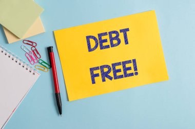 Writing note showing Debt Free. Business photo showcasing does not owning any money to any individual or companies Plain cardboard and writing equipment placed on pastel colour backdrop. clipart