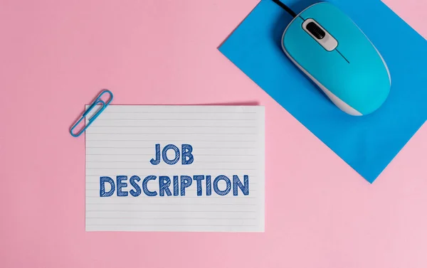 Text sign showing Job Description. Conceptual photo a formal account of an employee s is responsibilities Wire electronic mouse striped blank paper sheets clip colored background.