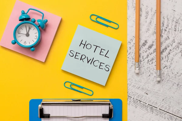 Writing note showing Hotel Services. Business photo showcasing Facilities Amenities of an accommodation and lodging house Notepads paper sheet clipboard markers alarm clock wooden background. — Stock Photo, Image