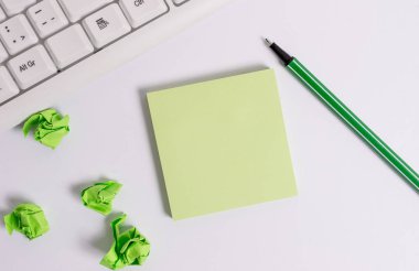Metin mesajları için boş not kağıdının üzerine düz bir şekilde döşenir. Beyaz arka plan ve pc klavye kalem ile Kare boş yeşil not kağıdı.