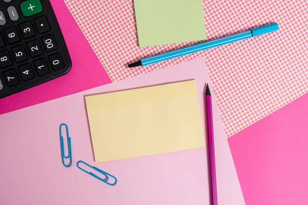 Stationary and notation papers placed above coloured backdrop. Writing equipments with note sheets on a plain table. Artistic way of arranging flat lays photography — Stock Photo, Image