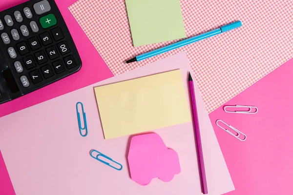 Stationary and notation papers placed above coloured backdrop. Writing equipments with note sheets on a plain table. Artistic way of arranging flat lays photography — Stock Photo, Image