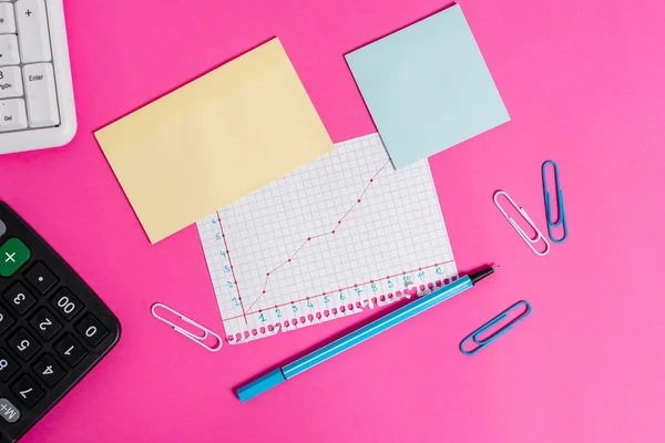 Writing equipment and note paper with mathematic sheet placed above a colored backdrop. Stationary also diagram picture on top of plain table. Artistic way of flat lays photography — Stock Photo, Image