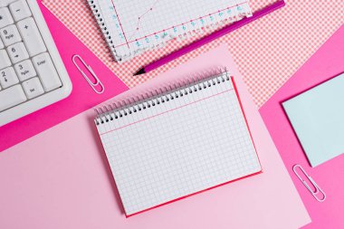 Yazma ekipmanları ve bilgisayar şeyleri artı renkli bir arkaplana yerleştirilmiş matematik kağıtları. Sabit, kalın kitap düz tablonun üzerindeki veri işleme makinesinin araçlarının yanında.