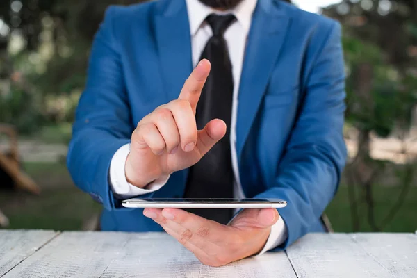 Affärsman med pekfingret framför sig. Affärsmannen håller Lap Top i handen och pekar med fingret. — Stockfoto