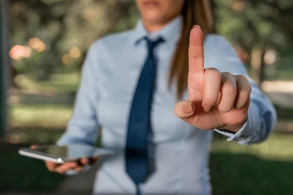 Handsome business girl pointing with finger into empty space. Copy space with pointing finger.