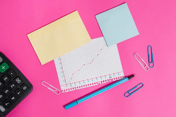 Writing equipment and note paper with mathematic sheet placed above a colored backdrop. Stationary also diagram picture on top of plain table. Artistic way of flat lays photography — Stock Photo, Image