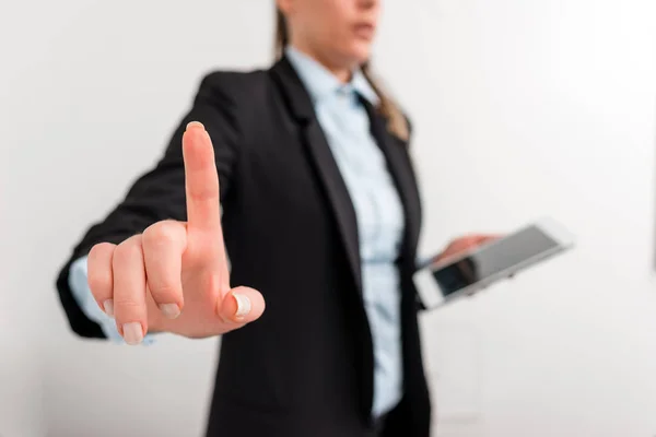 Business woman in black suite pointing with finger. Empty space for text message with hand and finger pointing on it. Digital business concept with business woman.