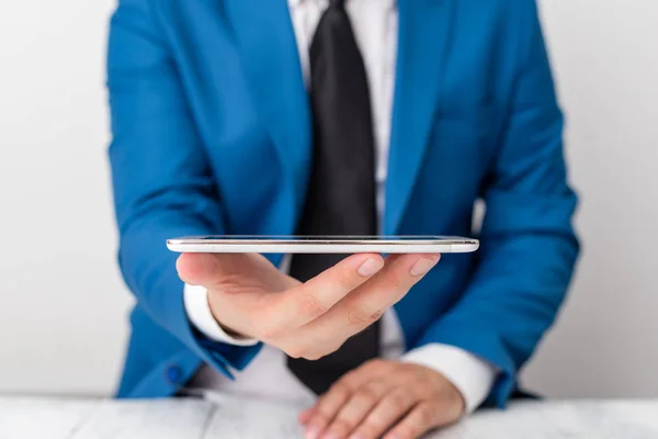 Businessman in blue suite with a tie holds lap top in hands. Business concept with man in a suite and a lap top.