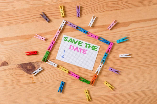 Writing note showing Save The Date question. Business photo showcasing asking someone to remember specific day or time Colored clothespin papers empty reminder wooden floor background office. — Stock Photo, Image