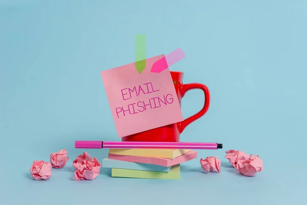 Writing note showing Email Phishing. Business photo showcasing Emails that may link to websites that distribute malware Coffee cup pen note banners stacked pads paper balls pastel background.