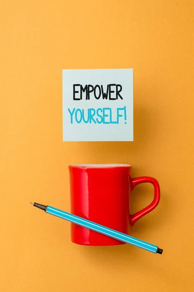 Writing note showing Empower Yourself. Business photo showcasing taking control of our life setting goals and making choices Front view coffee cup colored sticky note pen yolk color background. — Stock Photo, Image