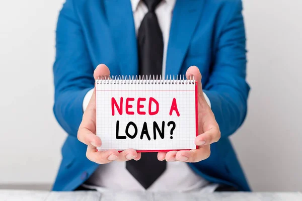 Handwriting text Need A Loan Question. Concept meaning asking he need money expected paid back with interest Man holds empty paper with copy space in front of him Copy Space. — Stock Photo, Image