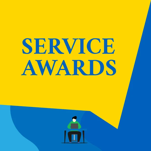 Writing note showing Service Awards. Business photo showcasing Recognizing an employee for his or her longevity or tenure Young man sitting chair desk working open laptop geometric background.