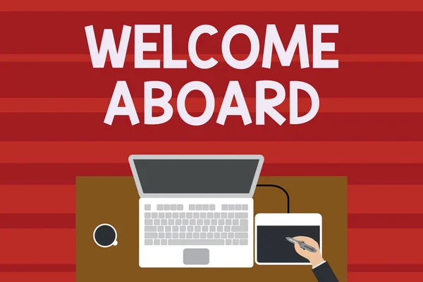 Text sign showing Welcome Aboard. Conceptual photo Expression of greetings to a demonstrating whose arrived is desired Upper view laptop wooden desk worker drawing tablet coffee cup office.