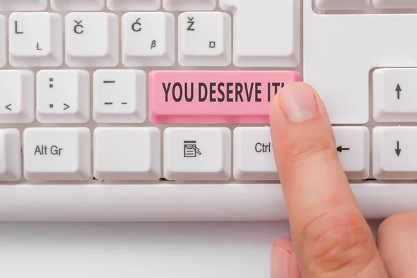 Text sign showing You Deserve It. Conceptual photo should have it because of their qualities or actions White pc keyboard with empty note paper above white background key copy space.