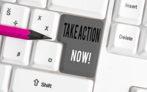 Handwriting text Take Action Now. Concept meaning do something official or concerted achieve aim with problem White pc keyboard with empty note paper above white background key copy space.