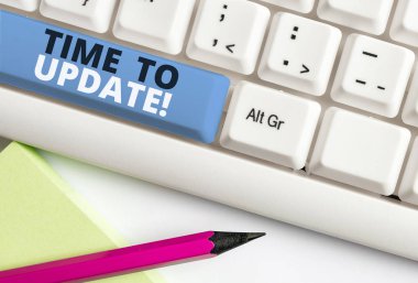El yazısı metin yazma Zaman Güncelleme. Kavram anlamı hareket bir şey veya güncelleştirilmiş sürüm programı Beyaz pc klavye beyaz arka plan tuşu kopyalama alanı üzerinde boş not kağıdı ile güncelleme.