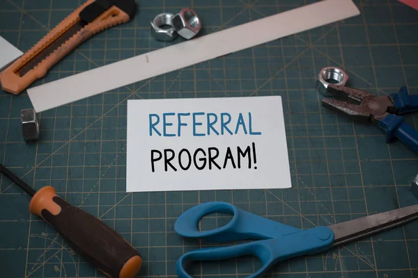 Handwriting text Referral Program. Concept meaning internal recruitment method employed by organizations Carpentry equipments and plain paper scattered everywhere on measuring mat.