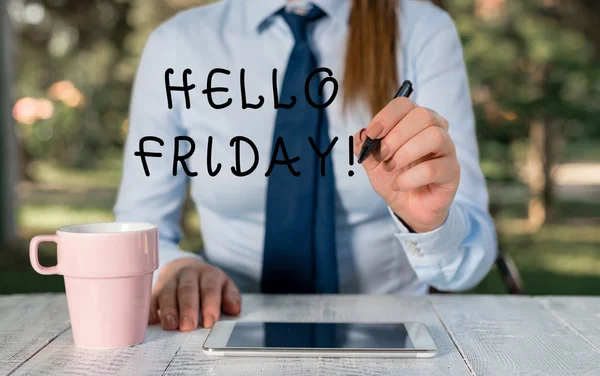 Writing note showing Hello Friday. Business photo showcasing used to express happiness from beginning of fresh week Female business person sitting by table and holding mobile phone.