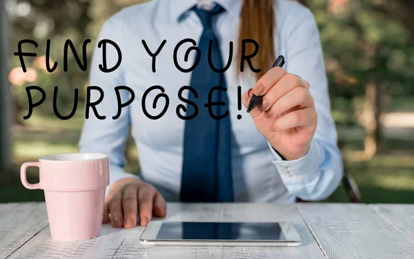 Writing note showing Find Your Purpose. Business photo showcasing reason for something is done or for which still exists Female business person sitting by table and holding mobile phone.
