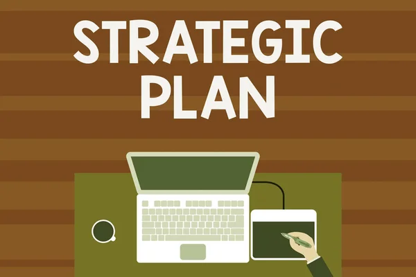 Text sign showing Strategic Plan. Conceptual photo A process of defining strategy and making decisions Upper view laptop wooden desk worker drawing tablet coffee cup office.