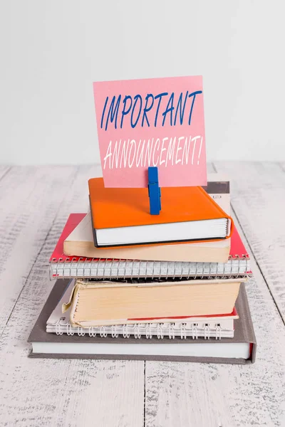 Handwriting text Important Announcement. Concept meaning spoken statement that tells showing about something pile stacked books notebook pin clothespin colored reminder white wooden.