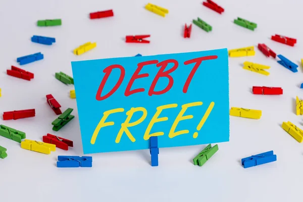 Text sign showing Debt Free. Conceptual photo does not owning any money or things to any individual or companies Colored clothespin papers empty reminder white floor background office.