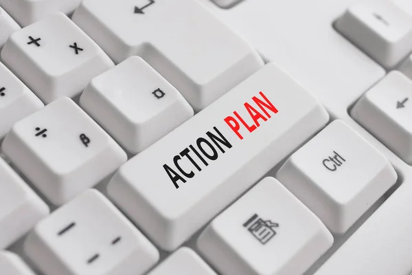 Writing note showing Action Plan. Business photo showcasing detailed plan outlining actions needed to reach goals or vision White pc keyboard with note paper above the white background.