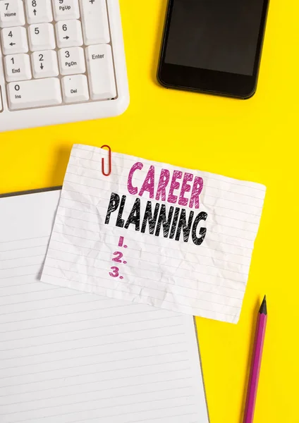 Text sign showing Career Planning. Conceptual photo Strategically plan your career goals and work success Crumpled white paper on table with paper clips clock mobile and pc keyboard.