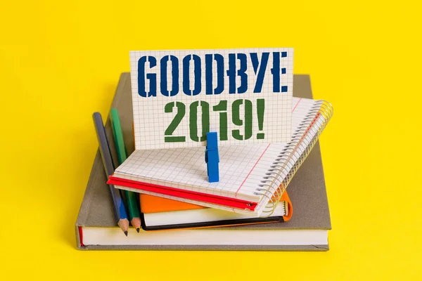 Writing note showing Goodbye 2019. Business photo showcasing express good wishes when parting or at the end of last year Book pencil rectangle shaped reminder notebook clothespins.