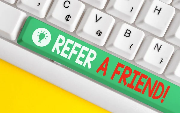 Text sign showing Refer A Friend. Conceptual photo direct someone to another or send him something like gift White pc keyboard with empty note paper above white background key copy space. — Stock Photo, Image