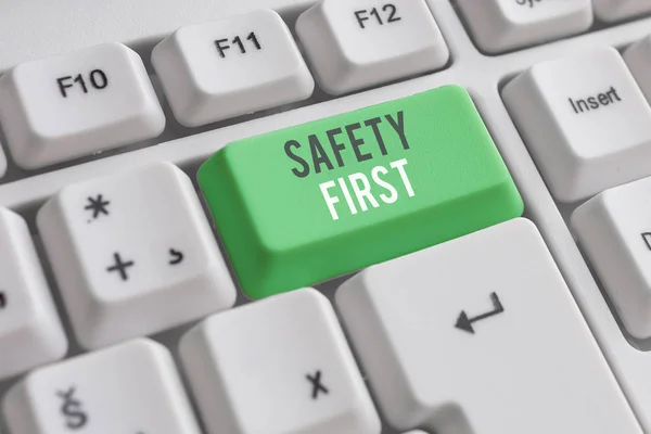 Handwriting text writing Safety First. Concept meaning used to say that the most important thing is to be safe White pc keyboard with empty note paper above white background key copy space. — Stock Photo, Image