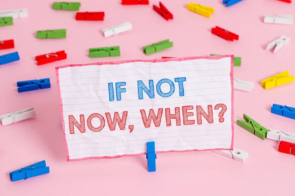 Text sign showing If Not Now When Question. Conceptual photo start acting from this moment do not hesitate Colored clothespin papers empty reminder pink floor background office pin.