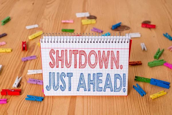 Handwriting text writing Shutdown Just Ahead. Concept meaning closing factory business either short time or forever Colored clothespin papers empty reminder wooden floor background office. — Stock Photo, Image