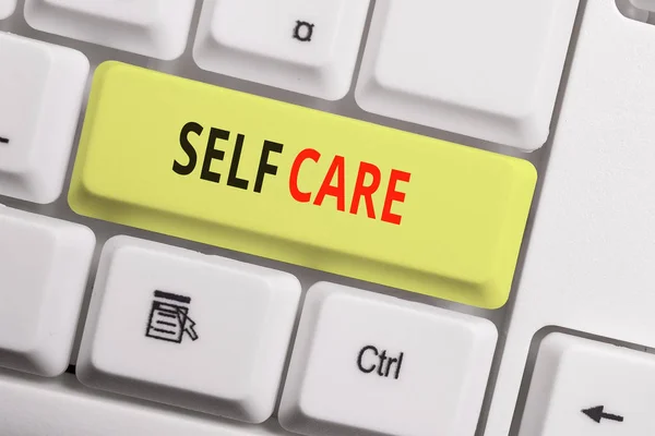 Text sign showing Self Care. Conceptual photo the practice of taking action to improve one s is own health White pc keyboard with empty note paper above white background key copy space. — Stock Photo, Image