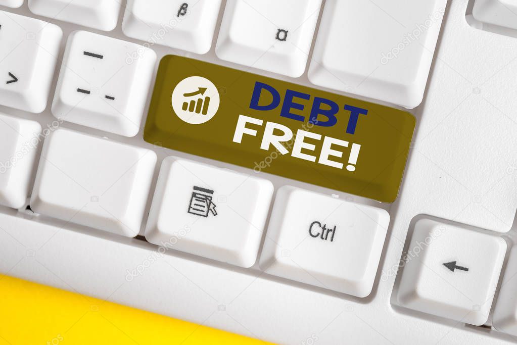 Conceptual hand writing showing Debt Free. Business photo showcasing does not owning any money or things to any individual or companies White pc keyboard with note paper above the white background.