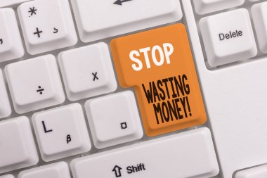 Parayı Israf Etmeyi Durdur'u gösteren metin işareti. Kavramsal fotoğraf advicing gösteren veya grup kaydetmeye başlamak ve akıllıca beyaz bilgisayar klavyesi beyaz arka plan tuş kopyalama alanı üzerinde boş not kağıdı ile kullanmak.