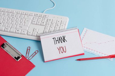 Teşekkür gösteren bir not yazmak. Bir hediye veya hizmet Kabul Ederken kullanılan kibar bir ifade vitrine İş fotoğrafı Kağıt mavi klavye ofis çalışma defter grafik numaraları notu.