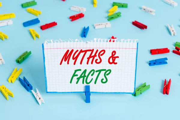 Text sign showing Myths And Facts. Conceptual photo usually traditional story of ostensibly historical events Colored clothespin papers empty reminder blue floor background office pin. — Stock Photo, Image