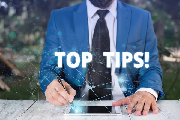 Handwriting text Top Tips. Concept meaning small but particularly useful piece of practical advice Male human wear formal work suit presenting presentation using smart device.