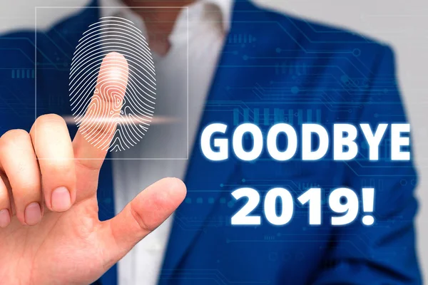 Conceptual hand writing showing Goodbye 2019. Business photo text express good wishes when parting or at the end of last year Male wear formal work suit presenting presentation smart device.