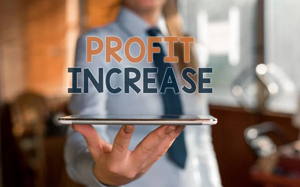 Writing note showing Profit Increase. Business photo showcasing the growth in the amount of revenue gained from a business Blurred woman in the background pointing with finger in empty space. — Stock Photo, Image