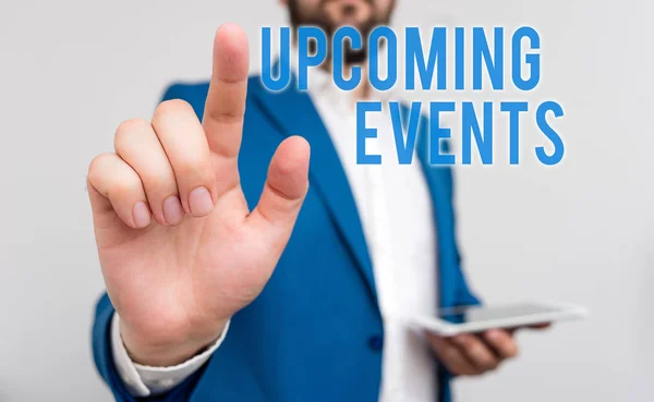 Conceptual hand writing showing Upcoming Events. Business photo text the approaching planned public or social occasions Businessman with pointing finger in front of him. — Zdjęcie stockowe