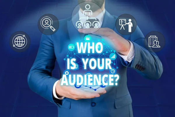 Writing note showing Who Is Your Audience Question. Business photo showcasing who is watching or listening to it Male human wear formal work suit presenting using smart device.
