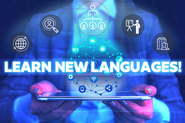 Word writing text Learn New Languages. Business concept for developing ability to communicate in foreign lang Male human wear formal work suit presenting presentation using smart device.