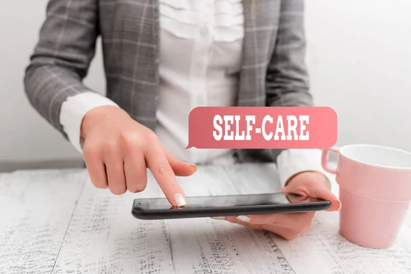 Handwriting text writing Self Care. Concept meaning practice of taking action preserve or improve ones own health Business concept with mobile phone in the hand. — Stock Photo, Image