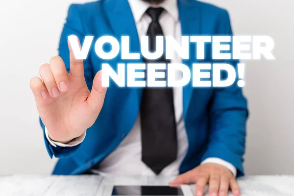 Handwriting text writing Volunteer Needed. Concept meaning need work for organization without being paid Businessman with pointing finger in front of him.